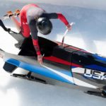 2 girls jumping in a bobsled